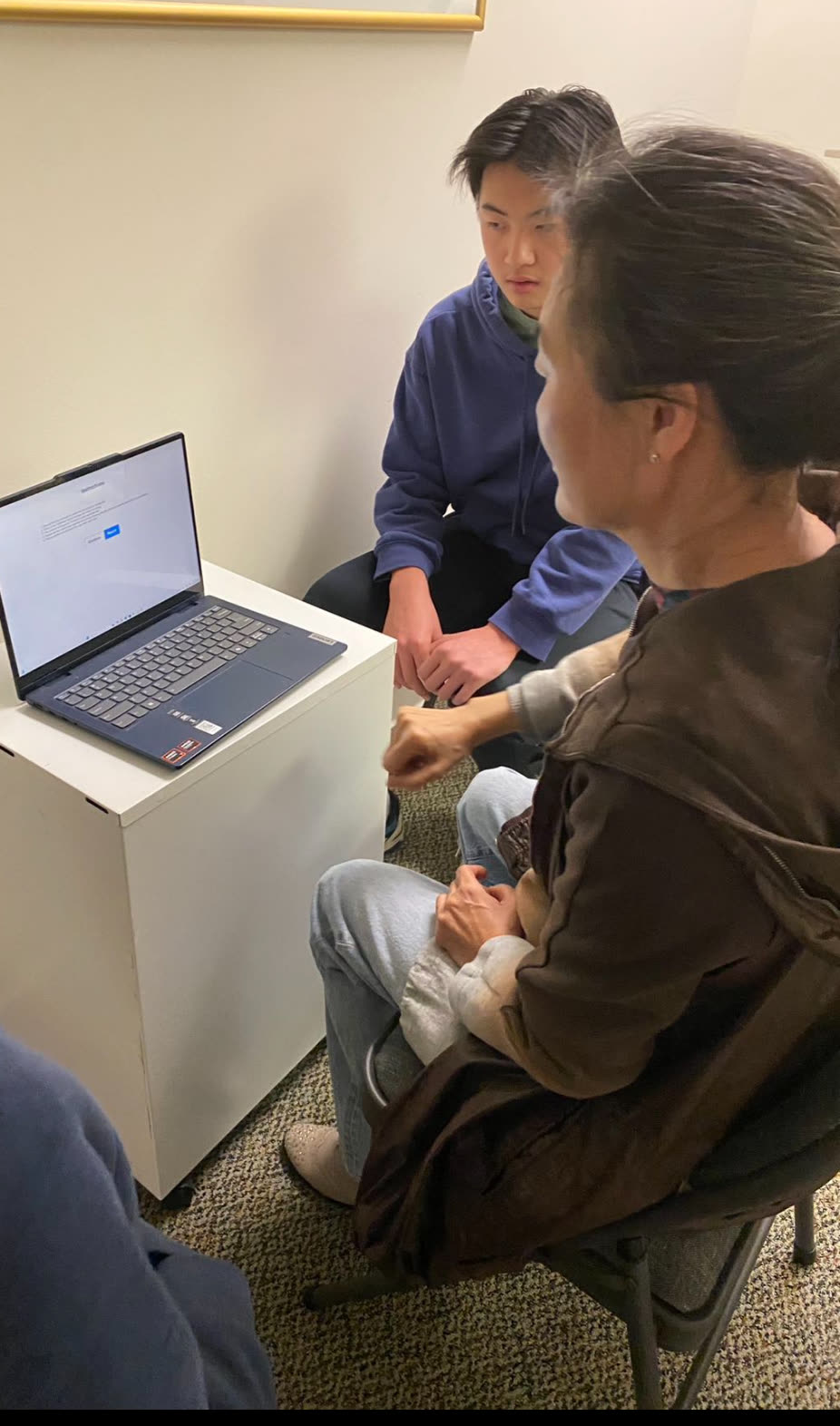 Eric observing a volunteer participant complete the ParkinsonAI hand-movement protocol