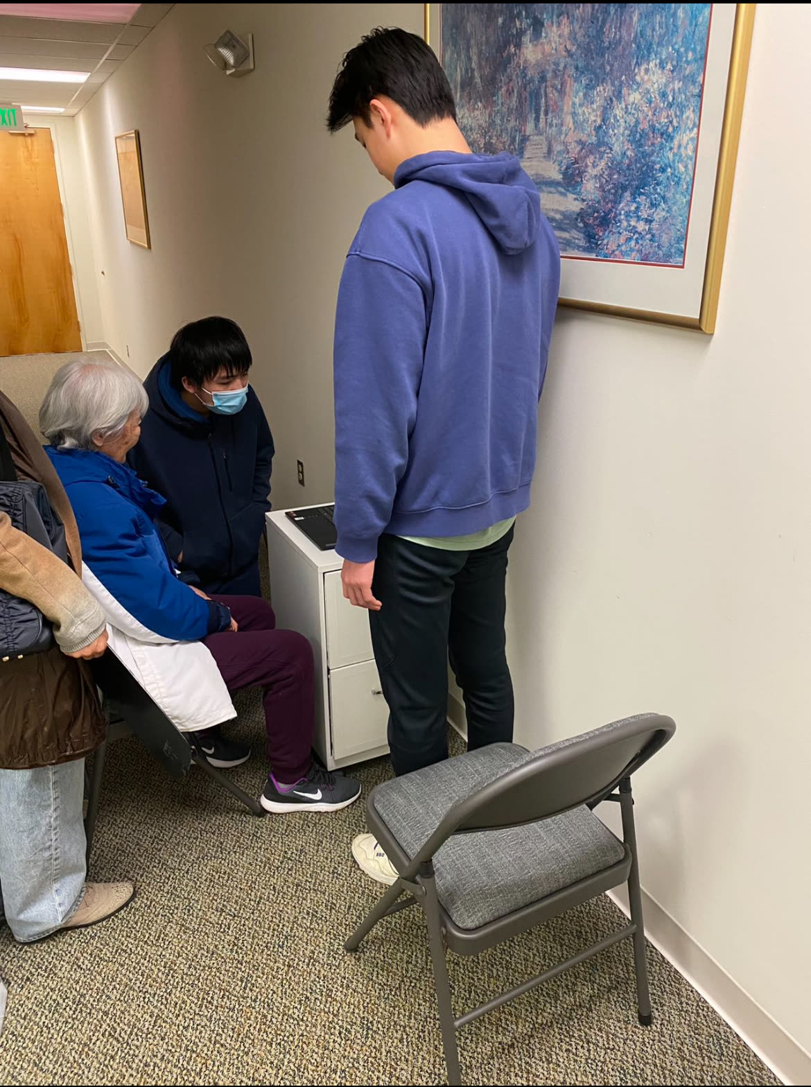 Eric and a teammate guiding an older volunteer participant through a ParkinsonAI field session